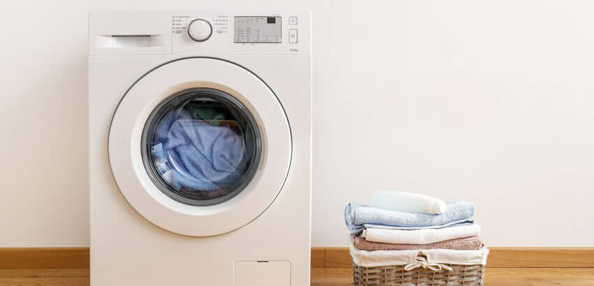 Image of washing machine with clothes being washed.