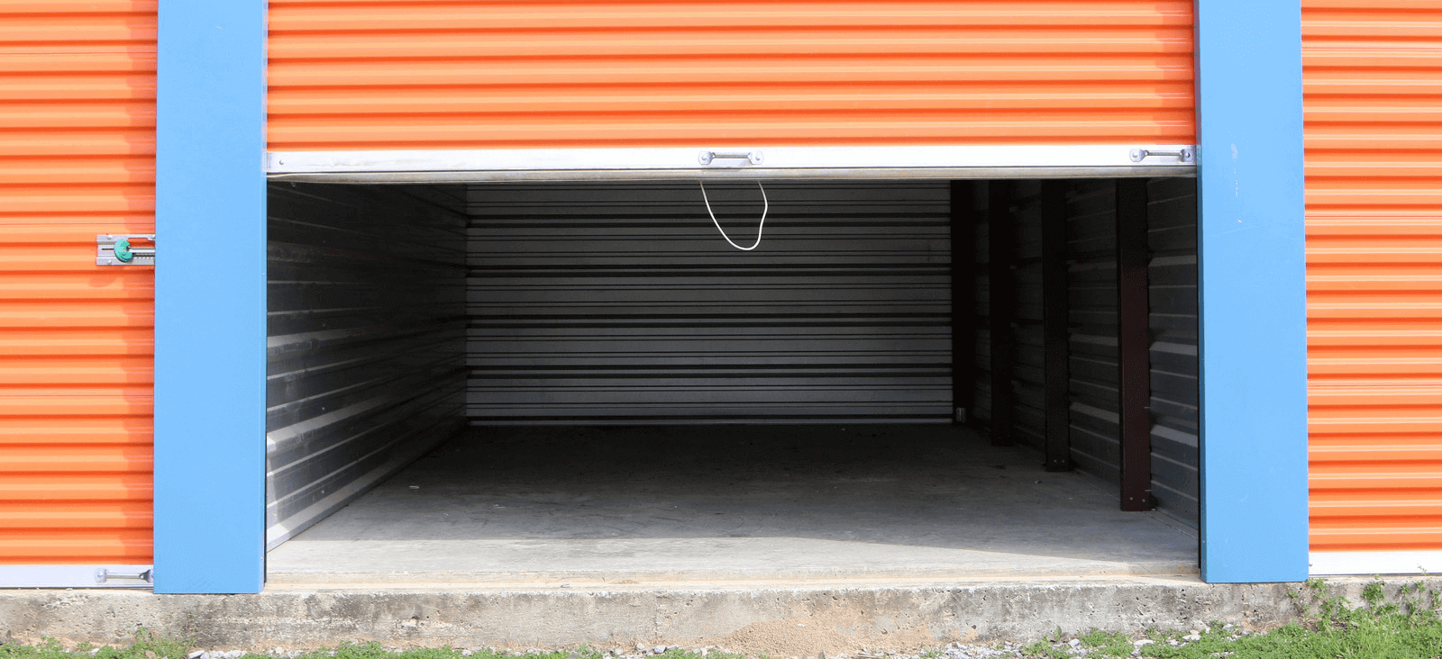 Outdoor self storage unit with the door half pulled down.
