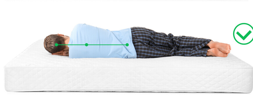 Image of person sleeping in the correct position on a mattress. 