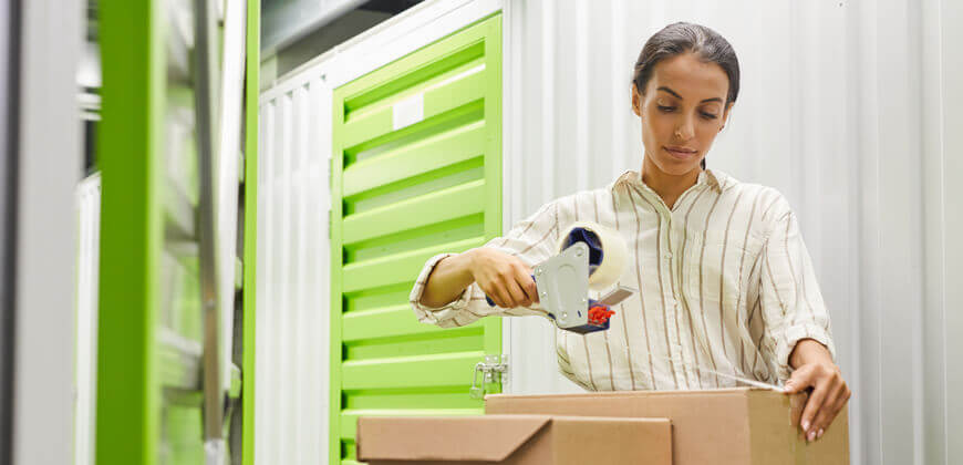 Image of a woman organising boxes in a self storage unit.