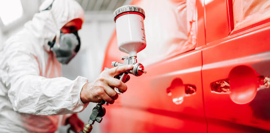 Image of a man maintaining a car's paintwork.