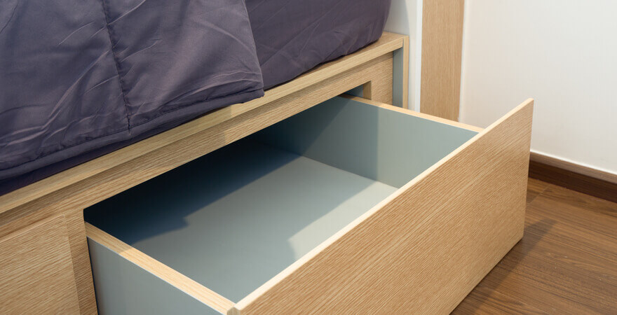Image of drawers under a bed. 