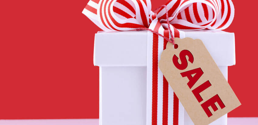 Image of a Christmas gift with a sale tag.
