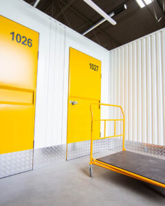 Indoor corridor with doors to storage containers.