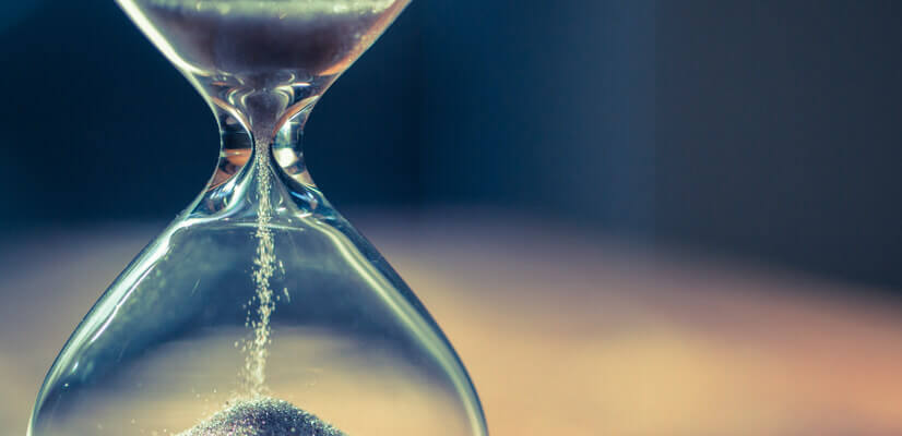 Image of hour glass with sand running through it.