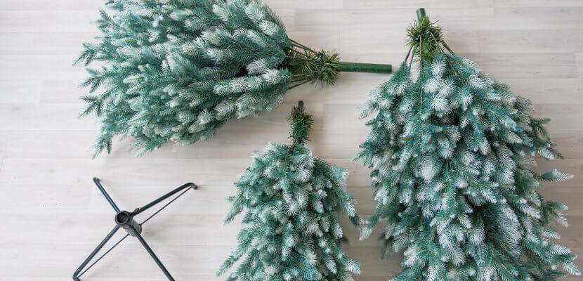 Image of artificial Christmas tree on floor taken apart. 