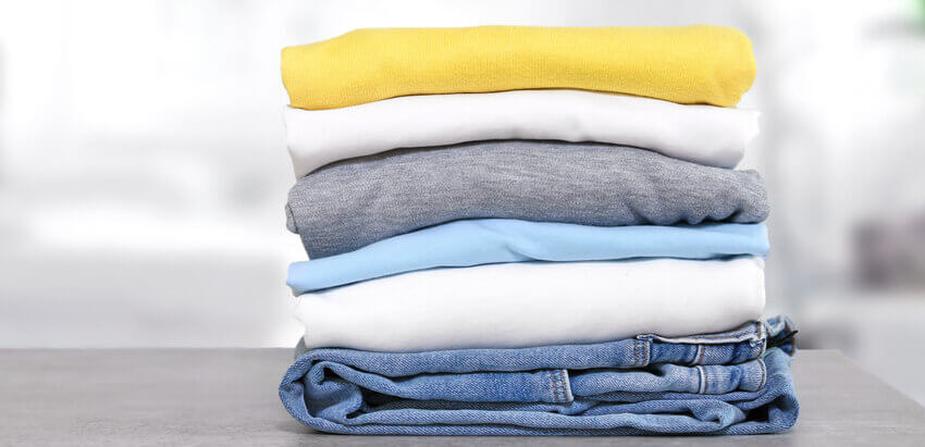 Image of pile of folded up clothes. 