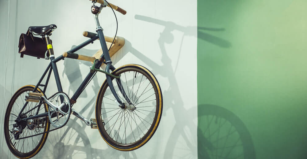 Image of bicycle stored on a wall.