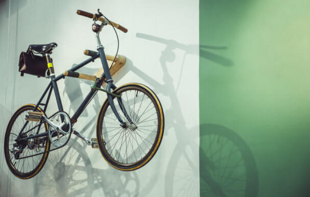 Image of bicycle stored on a wall.