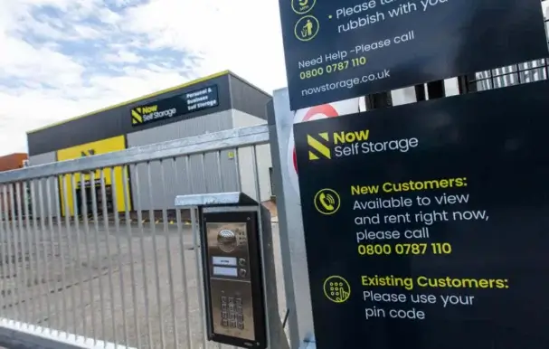 An exterior of a Now Storage facility with a metal gate