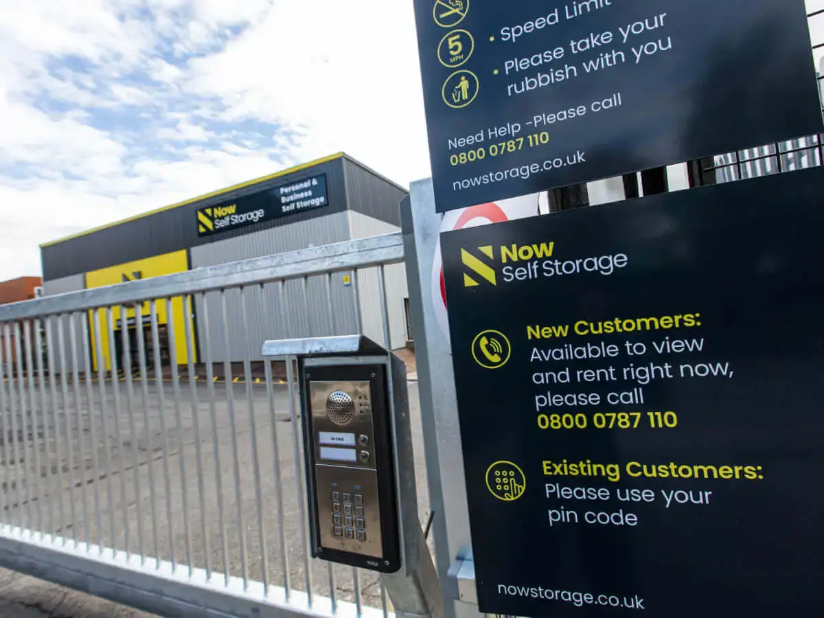 An exterior of a Now Storage facility with a metal gate