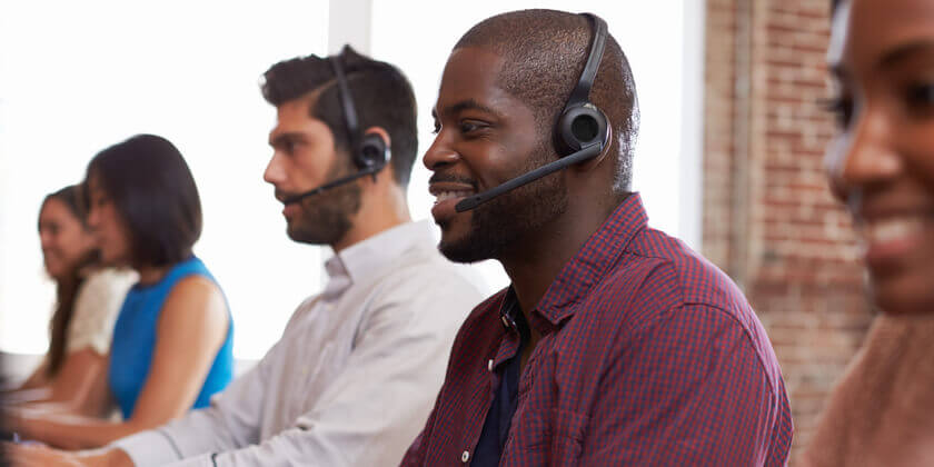 Image of customer service staff busy at the help desk.