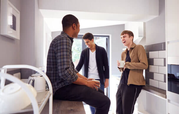 Images of young men relaxing in a student flat.
