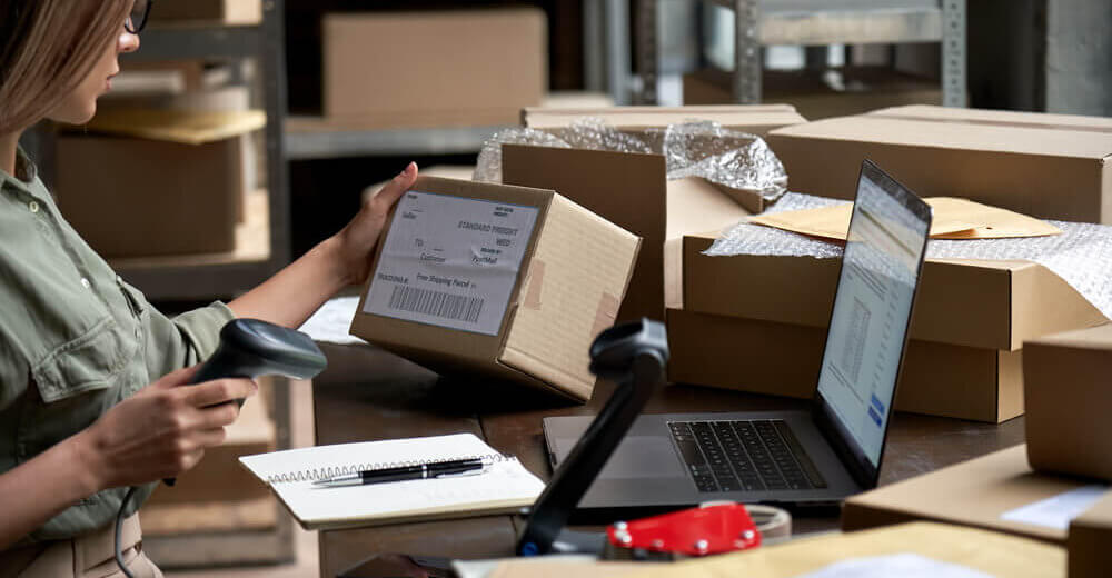 Image of a woman arranging product boxes.