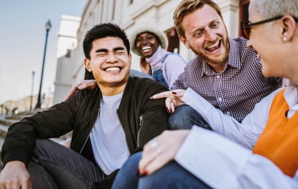 Image of students in conversation laughing together.