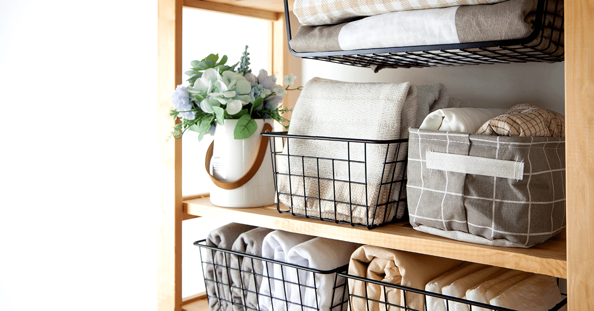 multigenerational storage, wooden vertical shelving with open baskets filled with towels and general household items