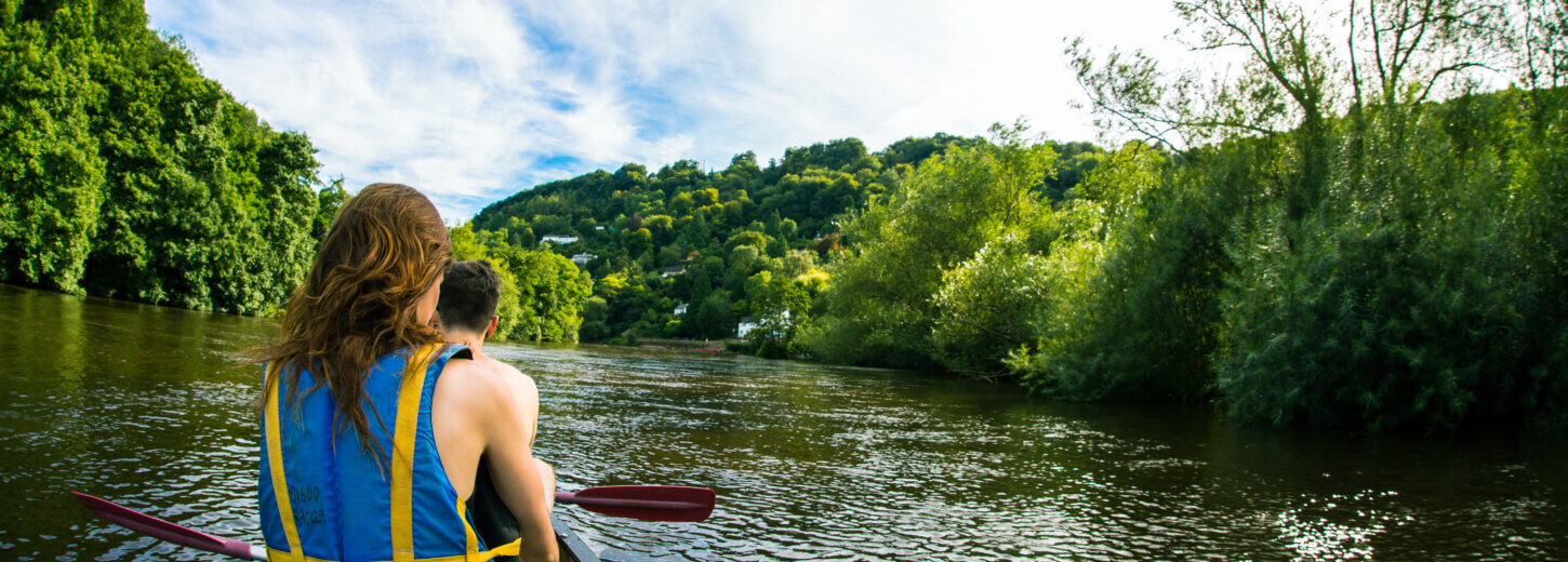 Two people canoeing along the river wye.
