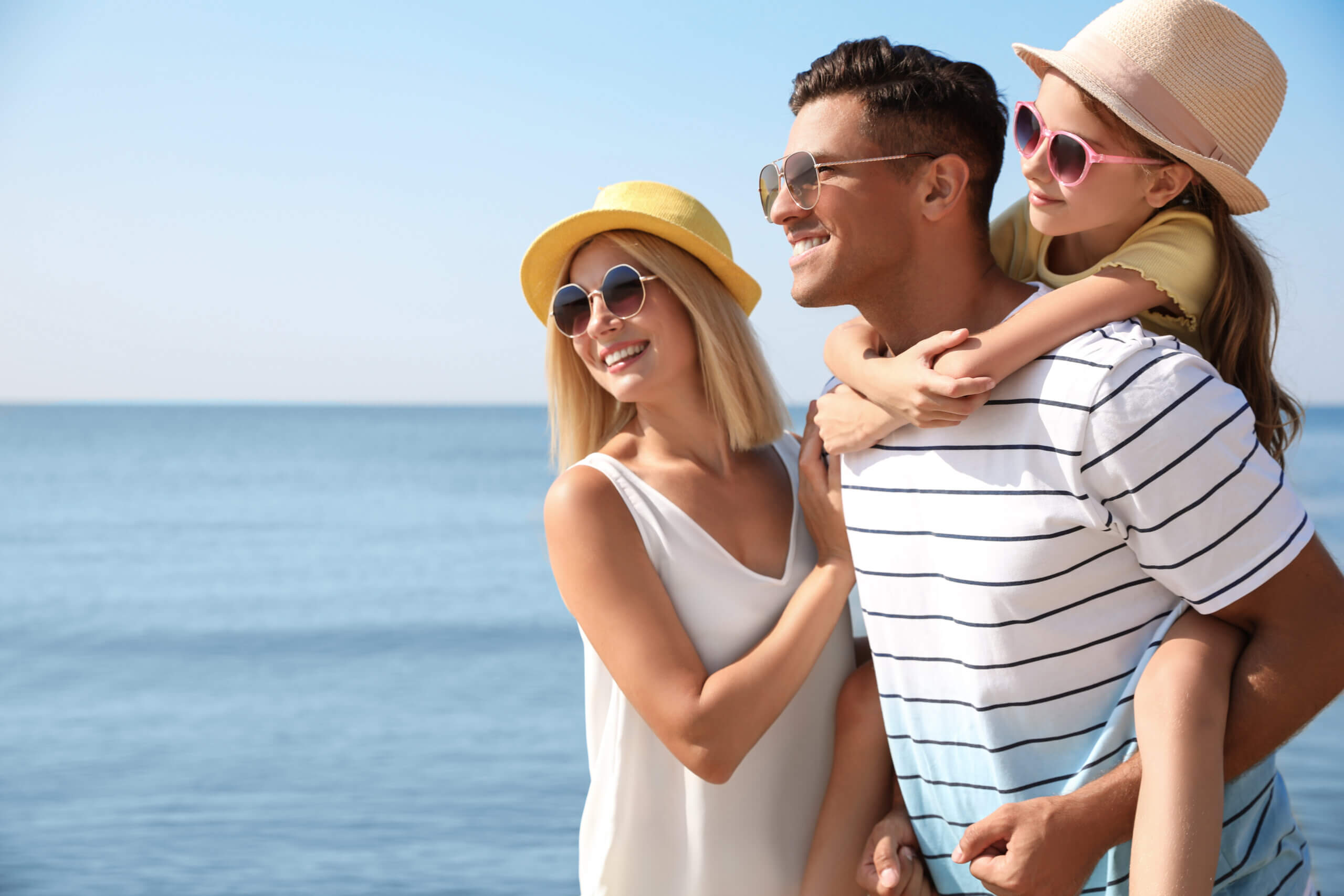An image of a family at the seaside enjoying the sunshine on their day trip from Basingstoke.