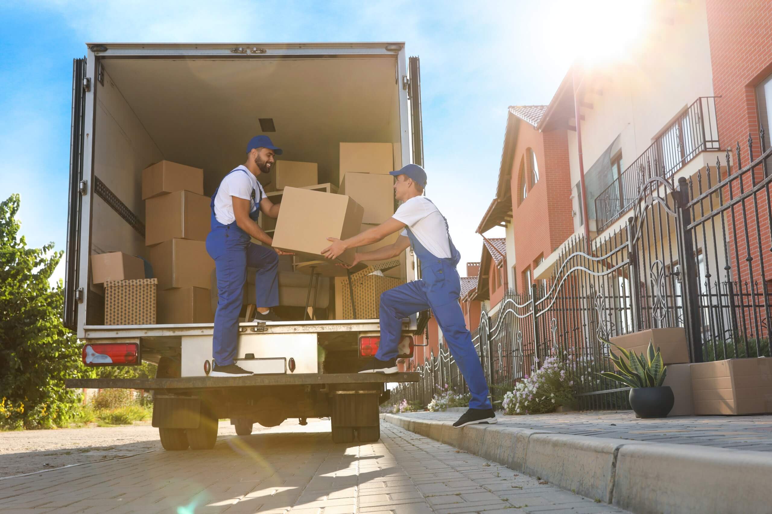 An image of two moving men moving boxes onto a lorry ready for moving them to Newbury.
