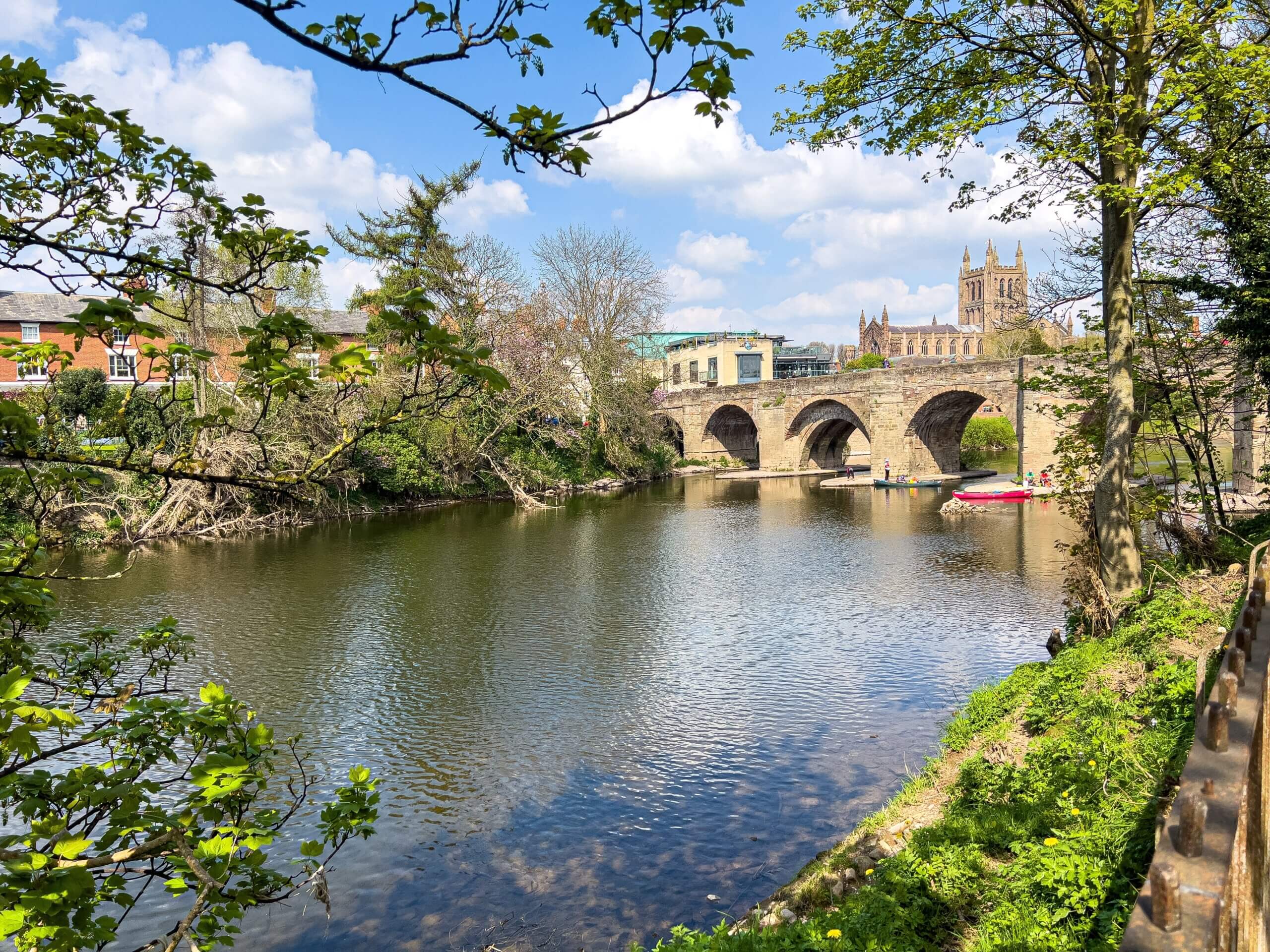An image of Hereford Cathedral in the distance across water.