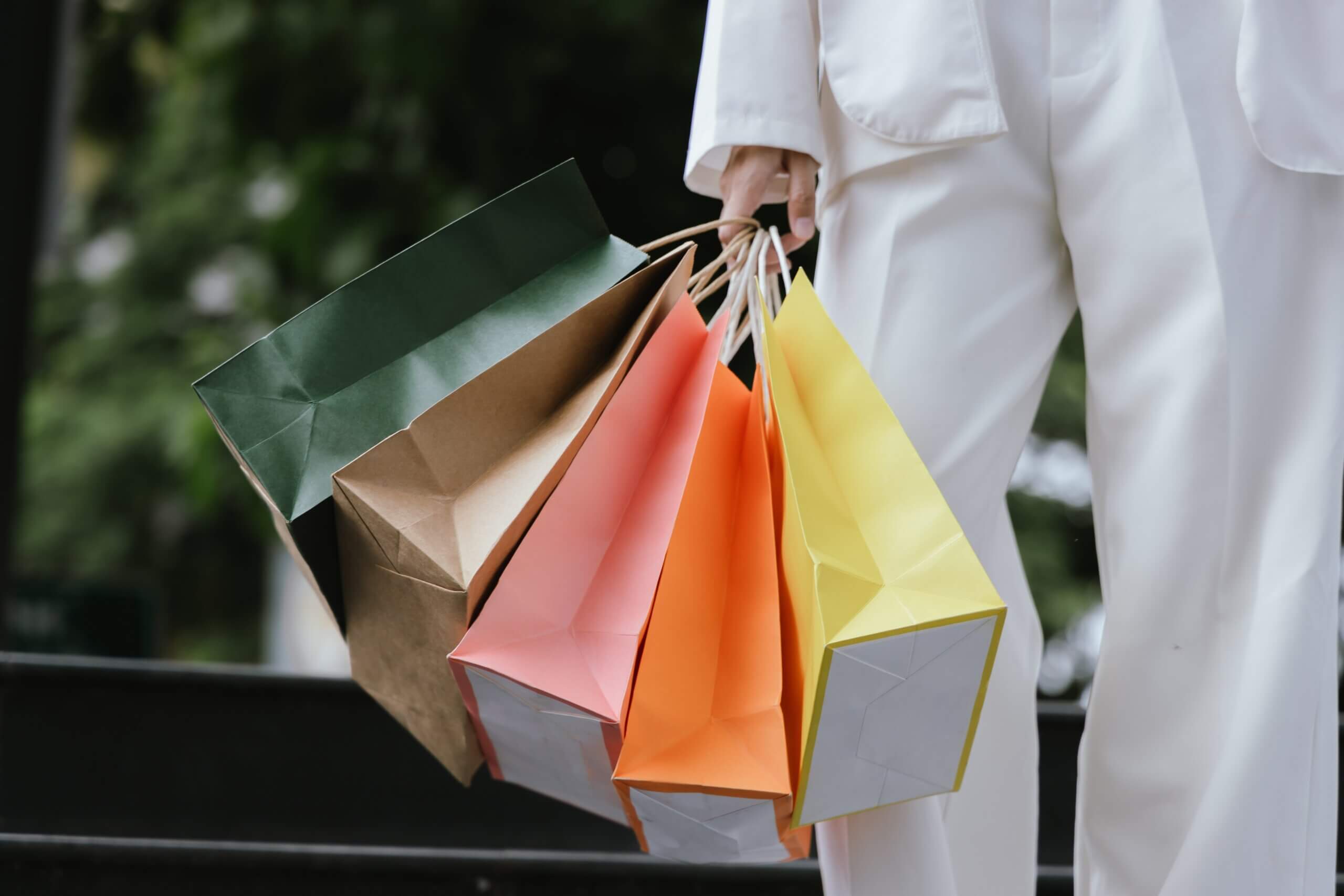 An image of a woman carrying a range of shopping bags after shopping in Lydney.